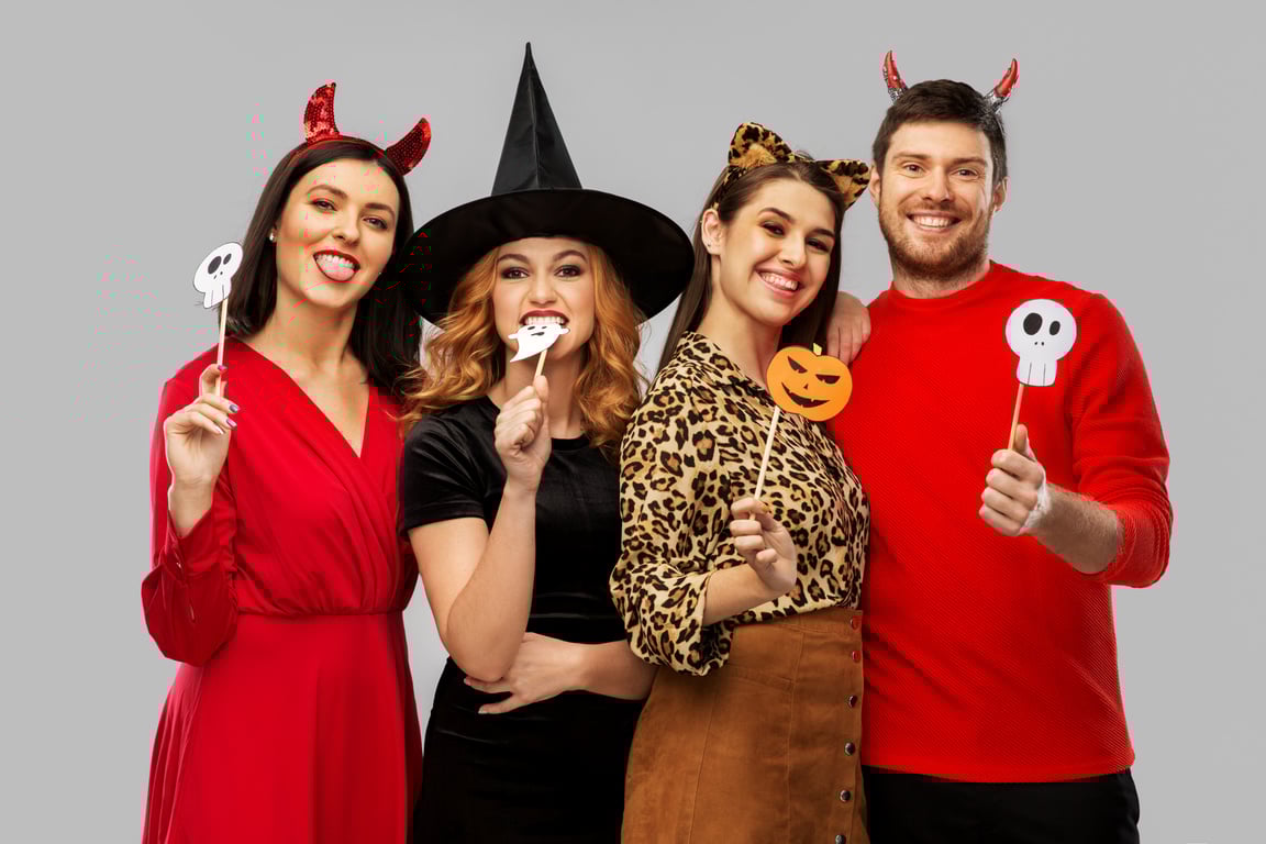 Friends in Halloween Costumes with Party Props
